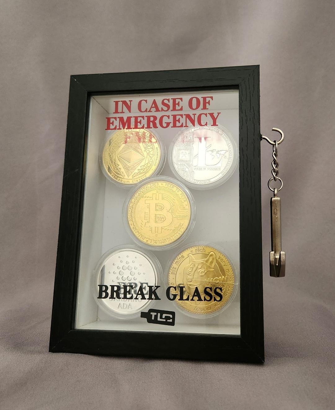 Emergency Break Glass Display Box filled with coins